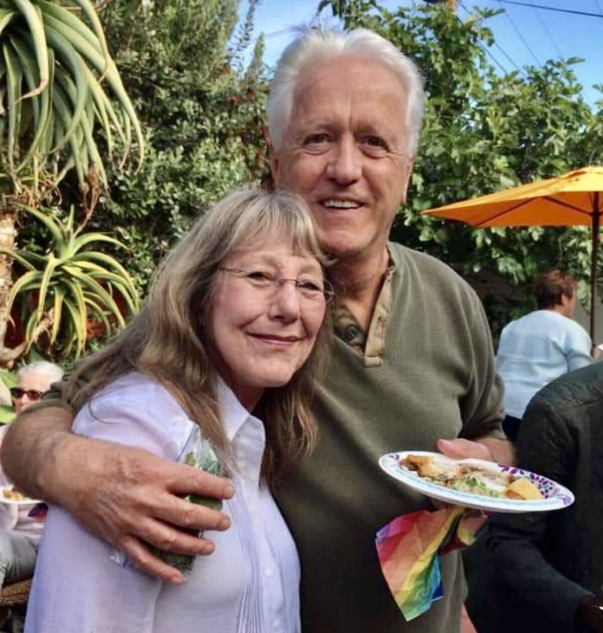 Gene Coster with past customer and friend, Liz Abbott, during a Quel Fromage reunion at Evelyn Goldman's house in May, 2019.