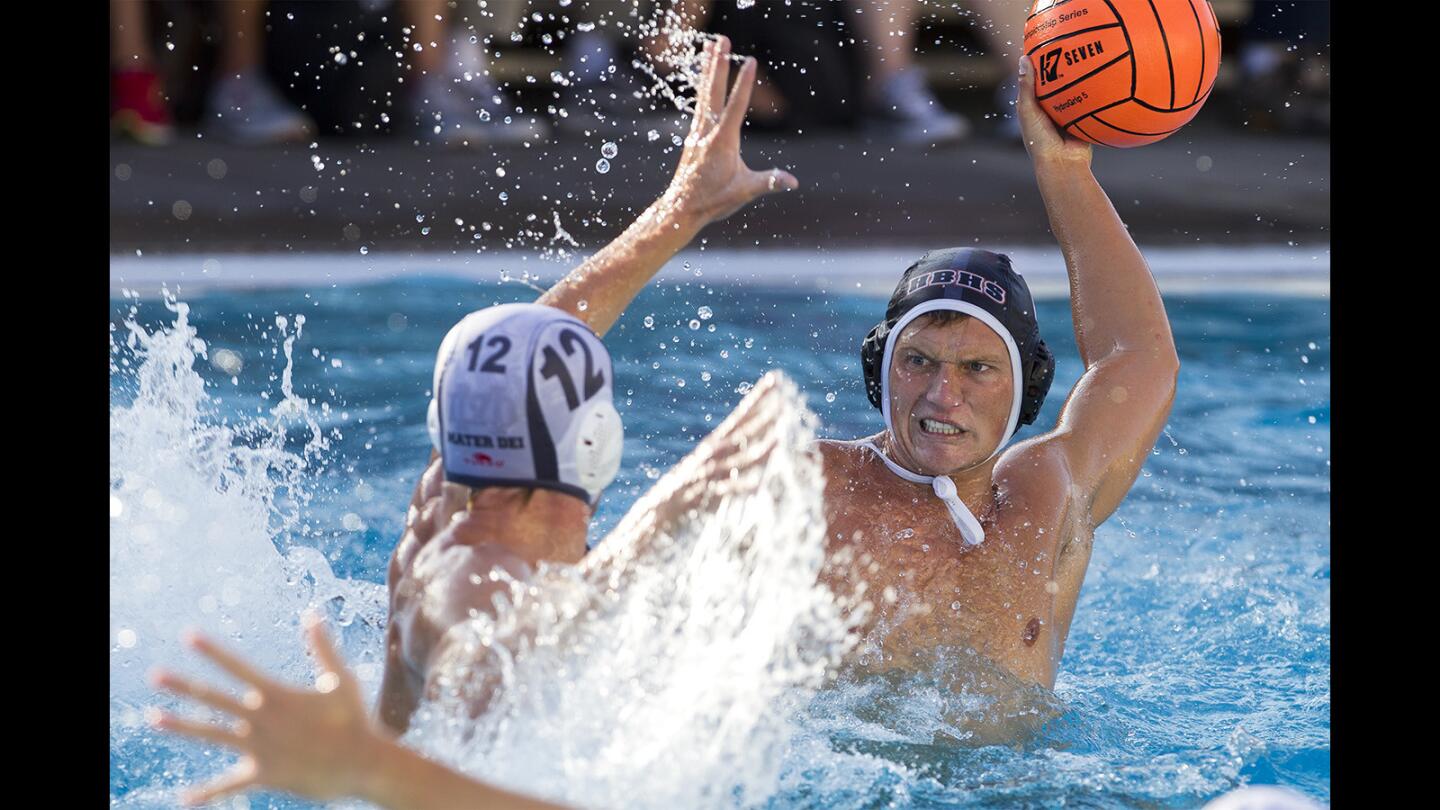 Huntington Beach's Curtis Jarvis takes a shot against Mater Dei's Ian Minsterman during a boys water polo game on Wednesday, September 20.