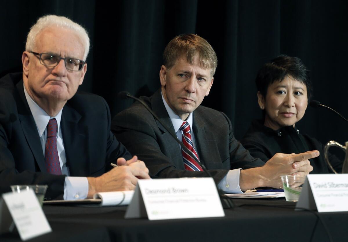 Consumer Financial Protection Bureau Director Richard Cordray, center, listens at a hearing in Denver where his agency's proposal to curtail mandatory arbitration was discussed on Wednesday, Oct. 7, 2015.
