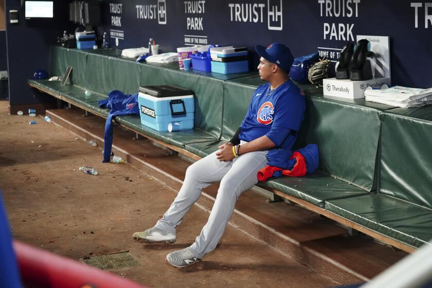 Chicago Cubs relief pitcher Daniel Palencia (48) sits on the bench after being defeated by the Atlanta Braves in a baseball game, Tuesday, Sept. 26, 2023, in Atlanta. (AP Photo/John Bazemore)