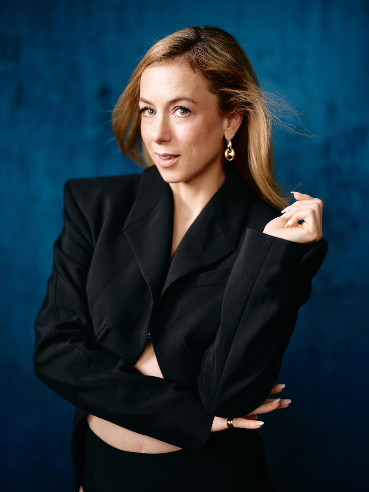 Portrait of comedian Iliza Shlesinger successful a achromatic jacket, looking sassy