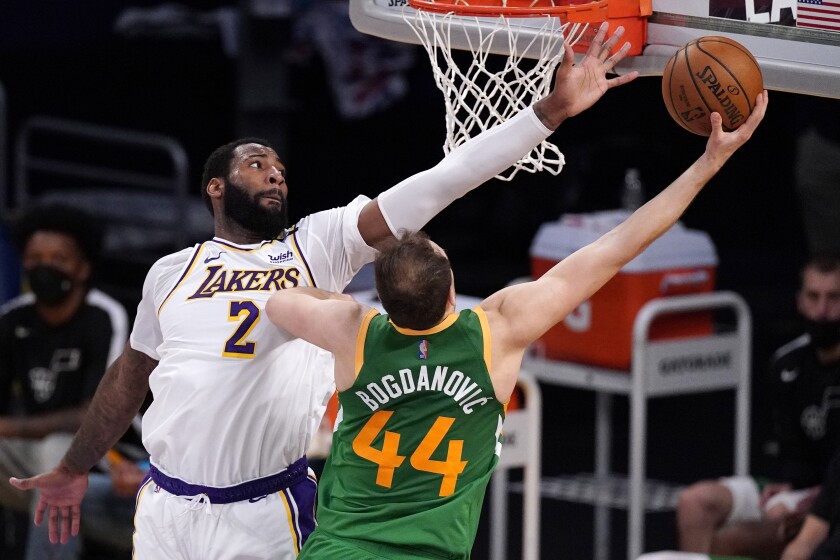 Lakers center Andre Drummond attempts to block a layup by Jazz forward Bojan Bogdanovic.