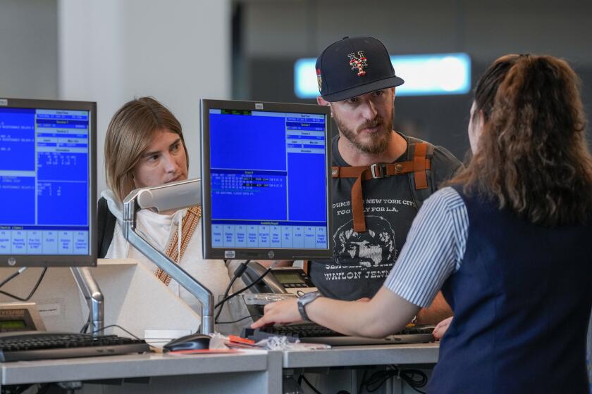 FILE - A airline agents helps a travelers in the departures area of Terminal B at LaGuardia Airport, Tuesday, June 27, 2023, in New York. The U.S. The U.S. Department of Transportation said Tuesday, April 16, 2024, that it will give the states power to investigate complaints about airlines and ticket sellers, and then refer cases to the federal government for enforcement. (AP Photo/Mary Altaffer, File)