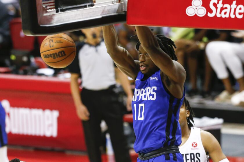 Los Angeles Clippers' Daniel Oturu (10) dunks against the Portland Trail Blazers during the first half of an NBA summer league basketball game Tuesday, Aug. 10, 2021, in Las Vegas. (AP Photo/Chase Stevens)