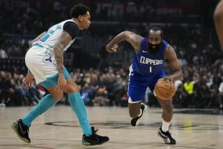 Hornets forward P.J. Washington defends against Clippers guard James Harden at Crypto.com Arena Tuesday