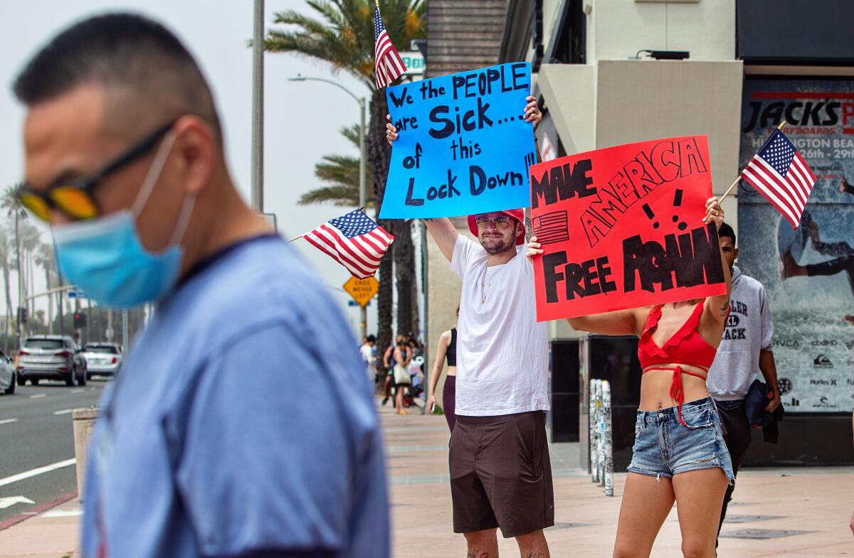Demonstrators protest the lockdown in March. These days some protesters are targeting health officials outside their homes.