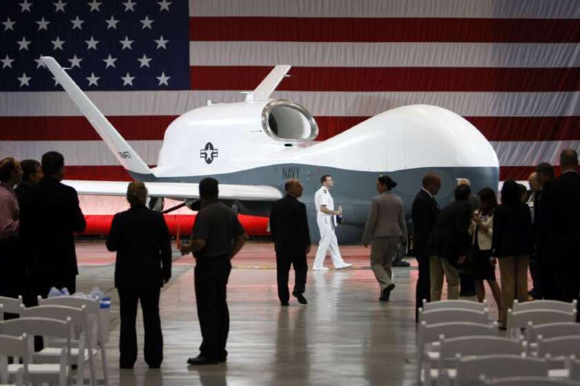 Officials view the naval version of Northrop Grumman Corp.'s Global Hawk spy drone at the company's Palmdale manufacturing facility.