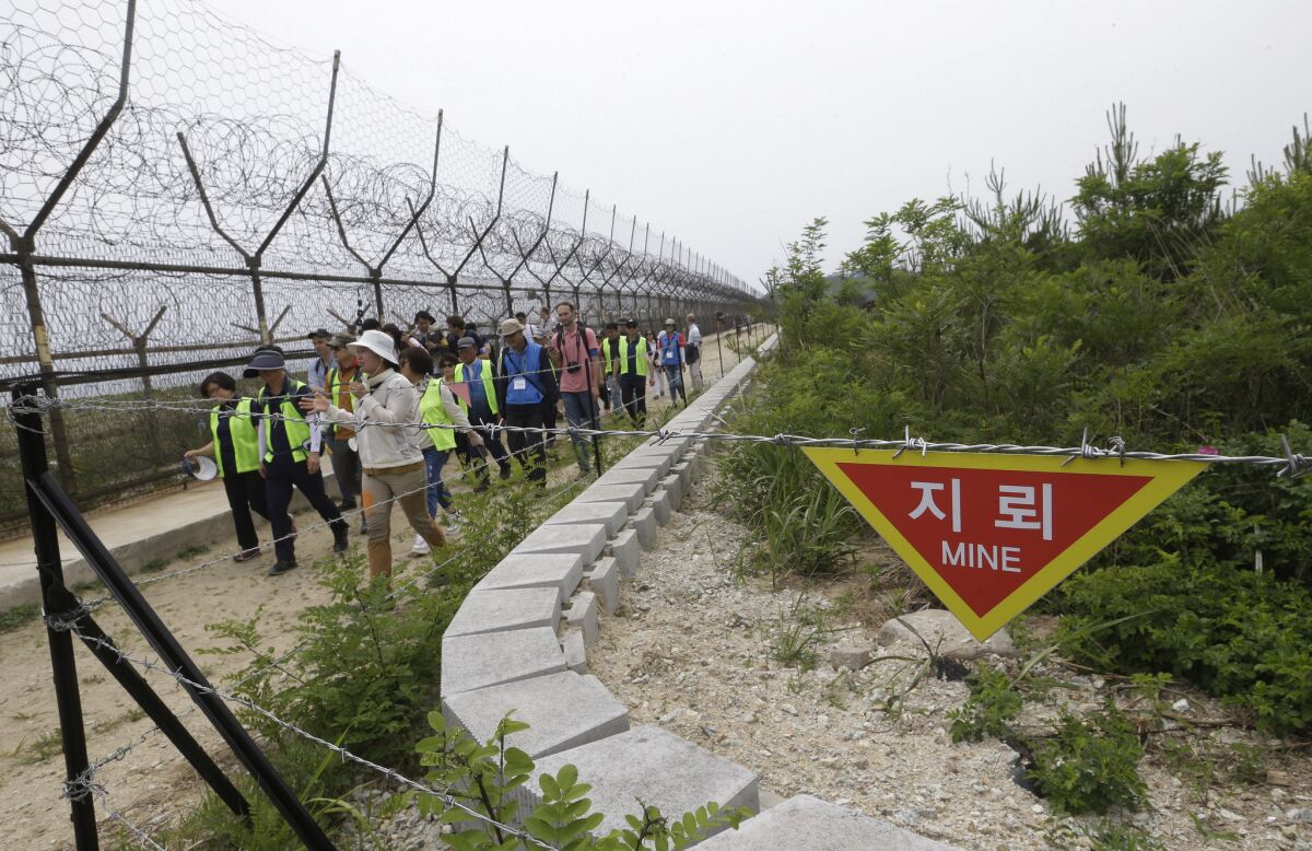 Hikers and journalists walk the DMZ Peace Trail in the demilitarized zone in Goseong, South Korea, this month.