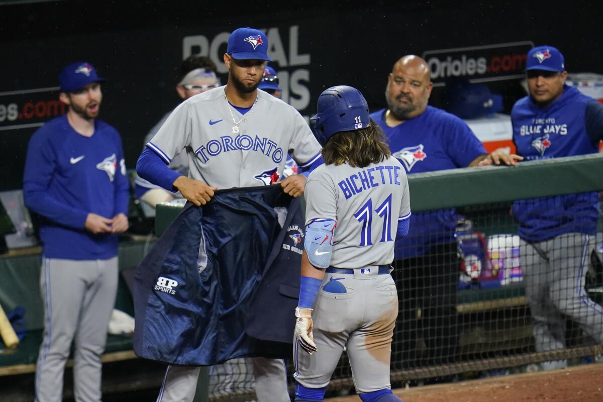 Toronto Blue Jays' Bo Bichette, right, is greeted near the dugout by Lourdes Gurriel Jr. after hitting a solo home run against the Baltimore Orioles during the seventh inning of the second game of a baseball doubleheader, Monday, Sept. 5, 2022, in Baltimore. (AP Photo/Julio Cortez)