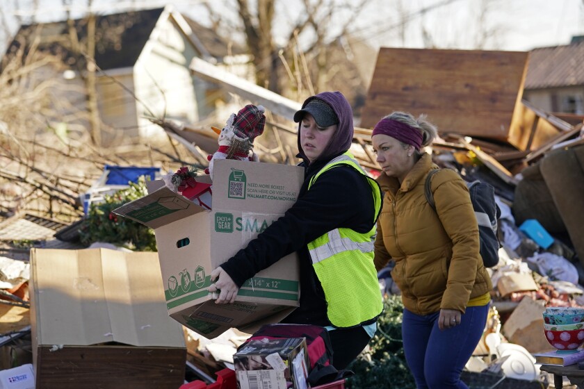 Volunteers help salvage possessions from the home of Martha Thomas in the aftermath of tornadoes that tore through the region, in Mayfield, Ky., Monday, Dec. 13, 2021. (AP Photo/Gerald Herbert)