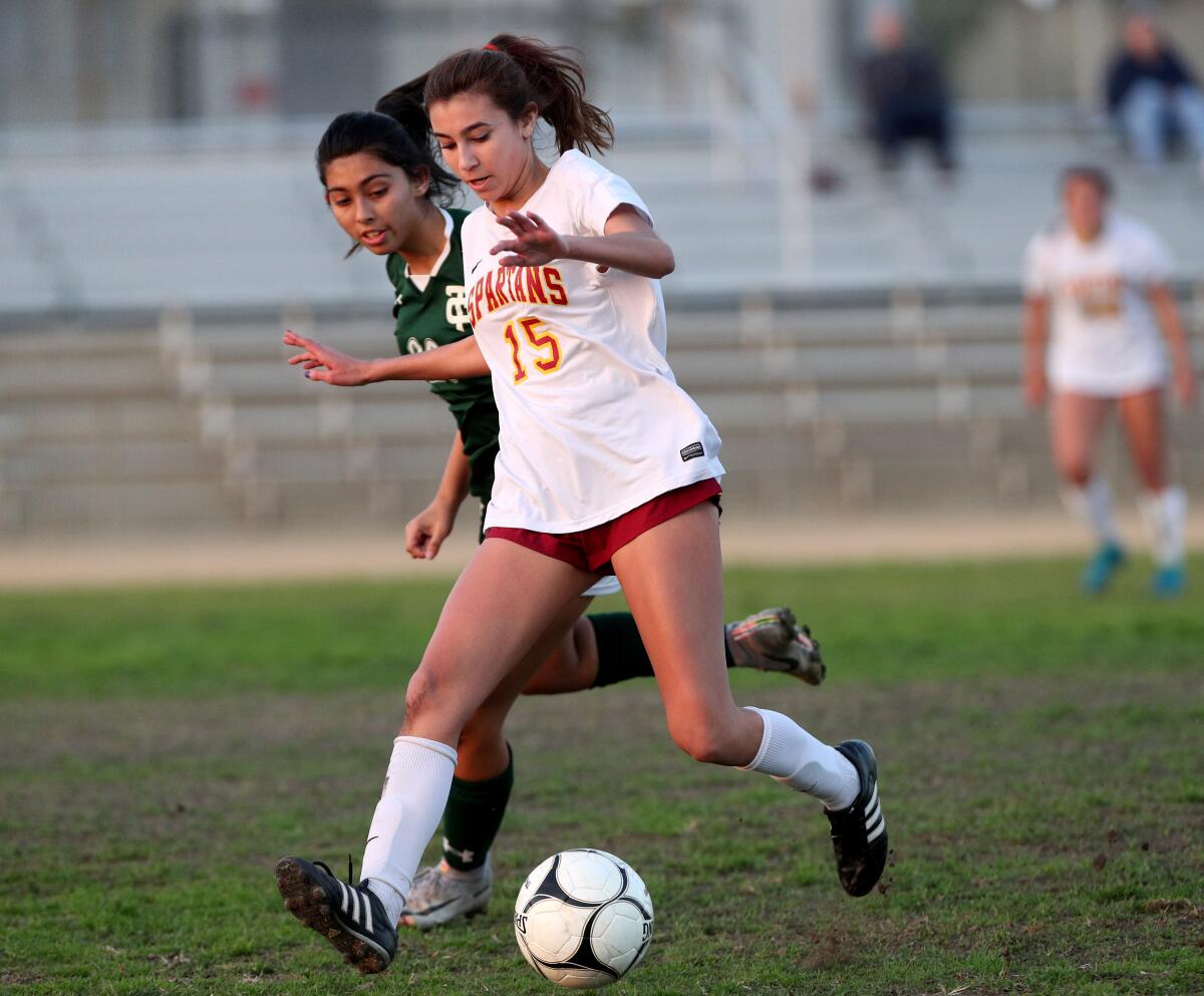 La Canada High School girls soccer player Natalie Godinez keeps the defender away from the ball in game vs. Temple City High in Temple City on Wednesday, Jan. 22, 2020.