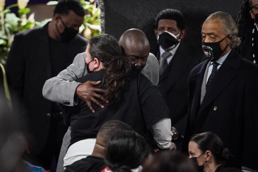 MINNEAPOLIS, MN - APRIL 21: Ben Crump hugs Katie Wright, mother Daunte Wright, during the public viewing service of Daunte Wright who was killed by a Brooklyn Center Police officer during the trail of former ex Minneapolis police officer Dereck Chauvin who was convicted for murdering George Floyd on Wednesday, April 21, 2021 in Minneapolis, MN. (Jason Armond / Los Angeles Times)