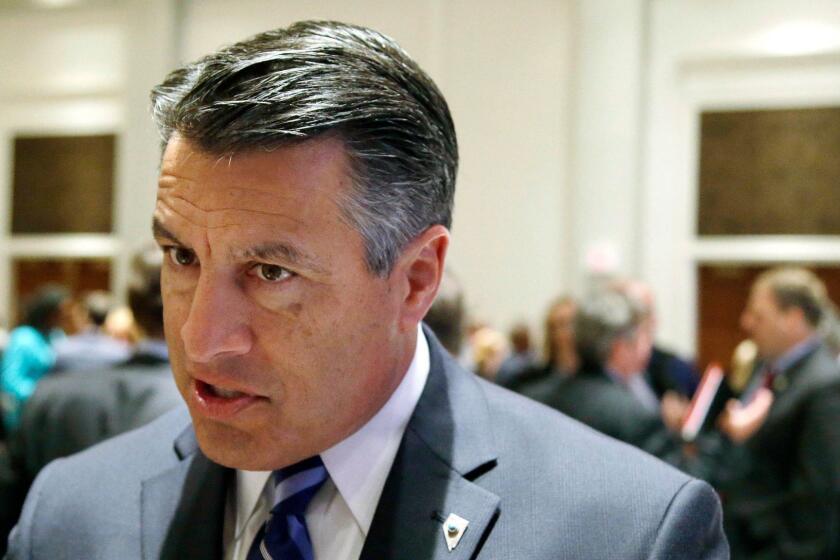 Nevada Republican Gov. Brian Sandoval responds to reporter's questions about health care and the opioid epidemic after a session called "Curbing The Opioid Epidemic" at the first day of the National Governor's Association meeting Thursday, July 13, 2017, in Providence, R.I. (AP Photo/Stephan Savoia)