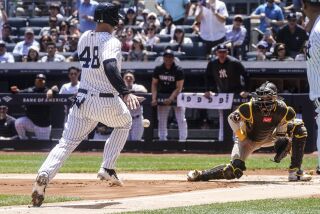 New York Yankees Anthony Rizzo runs to home plate but is caught out by San Diego Padres catcher Brett Sullivan during first inning of a baseball game, Saturday, May 27, 2023, in New York. (AP Photo/Bebeto Matthews)