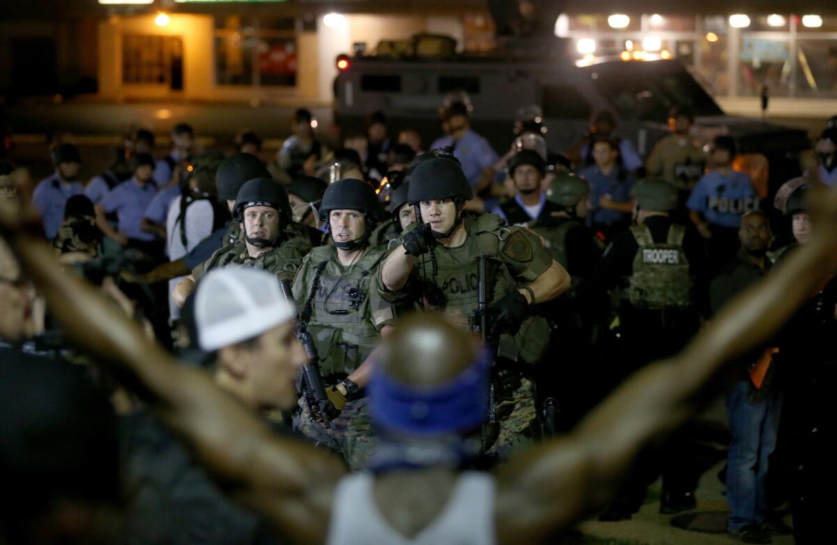 Police face off with demonstrators Aug. 19 in Ferguson, Mo.