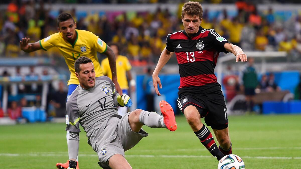 Germany forward Thomas Mueller, right, controls the ball in front of Brazil goalkeeper Julio Cesar during Germany's World Cup semifinal win. Stopping Germany's potent offense will be a challenge for Argentina in the World Cup final.