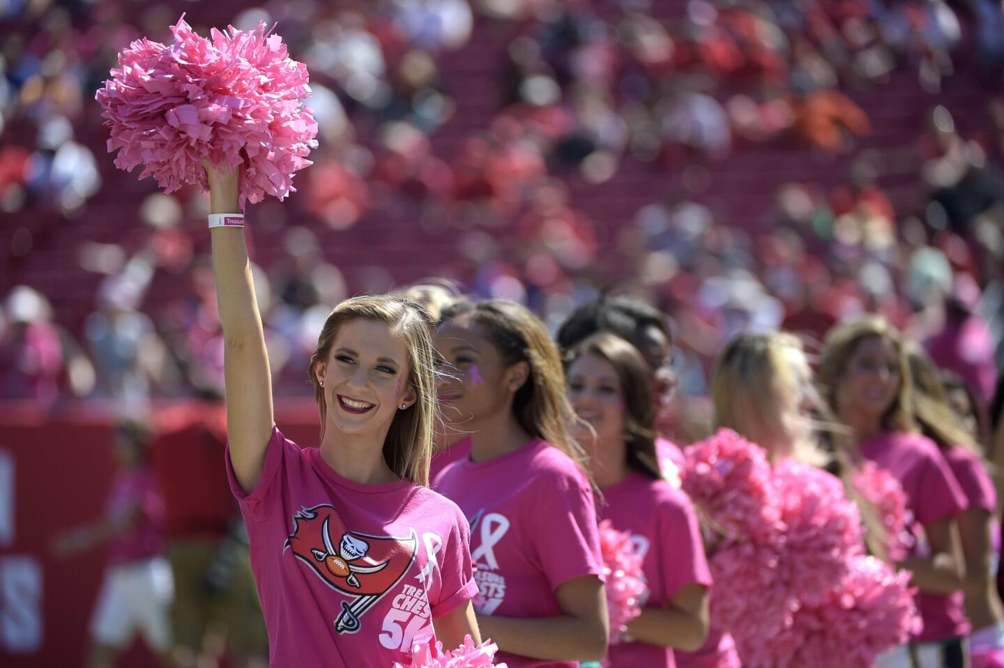 University of South Florida cheerleaders participate in a production in support of Breast Cancer Awareness Month during halftime of an NFL football game between the Tampa Bay Buccaneers and the Jacksonville Jaguars in Tampa, Fla., Sunday, Oct. 11, 2015. (AP Photo/Phelan M. Ebenhack)