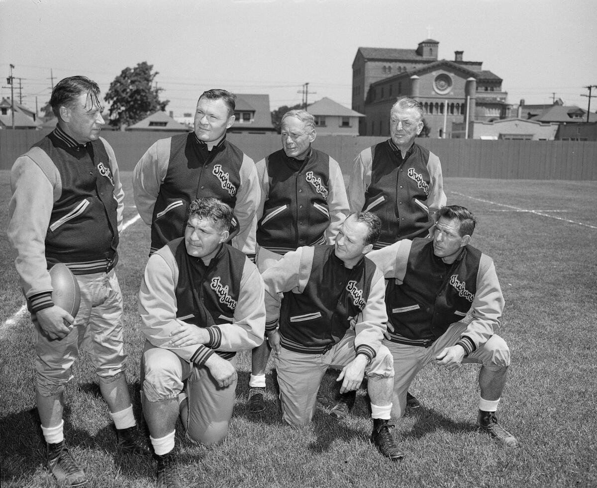USC coach Jeff Cravath, left, gets together with his staff in 1949.