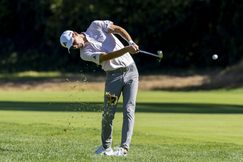 PACIFIC PALISADES, CA - FEBRUARY 18, 2022: Joaquin Niemann sends the turf flying as he hits his approach shot on the 12th hole during the second round of the Genesis Invitational at Riviera Country Club on February 18, 2022 in Pacific Palisades, California. He currently holds the lead at 16-under par.(Gina Ferazzi / Los Angeles Times)