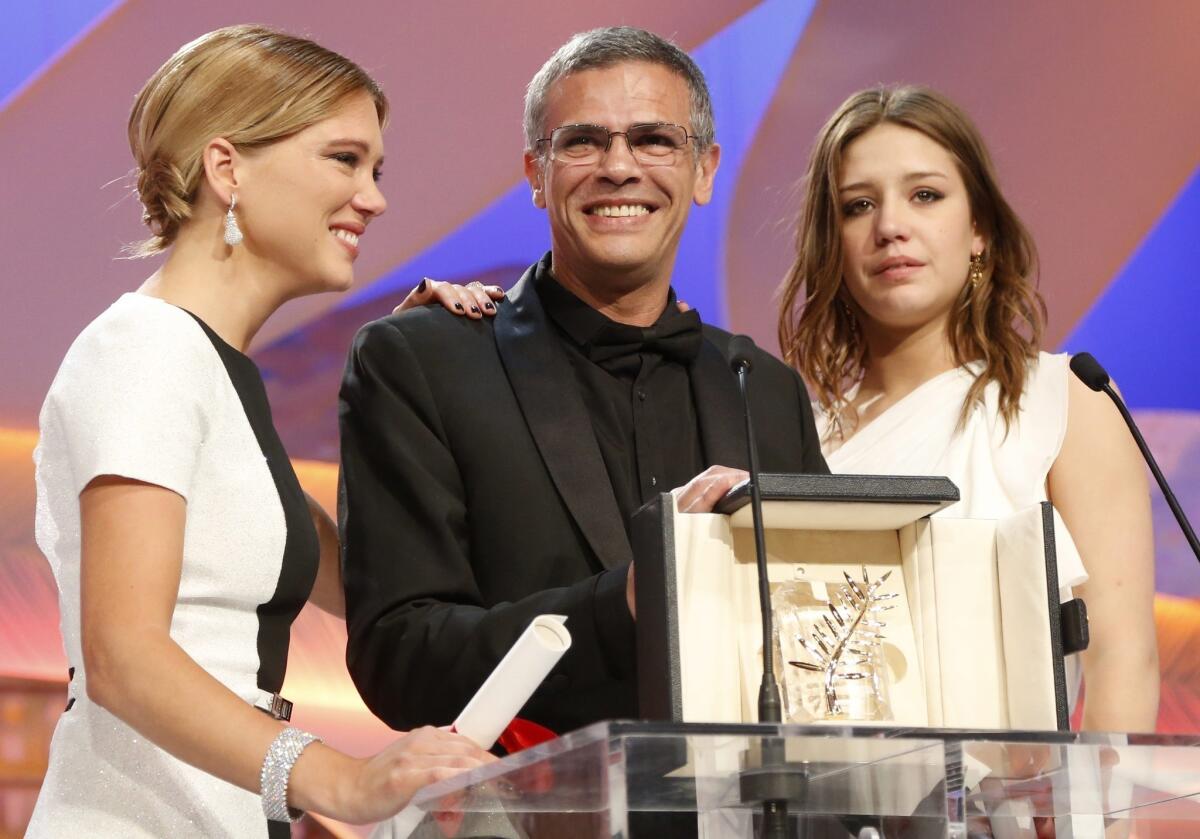 Director Abdellatif Kechiche, center, and stars Lea Seydoux, left, and Adele Exarchopoulos receive the Palme d'Or award at the Cannes Film Festival for "Blue Is the Warmest Color."