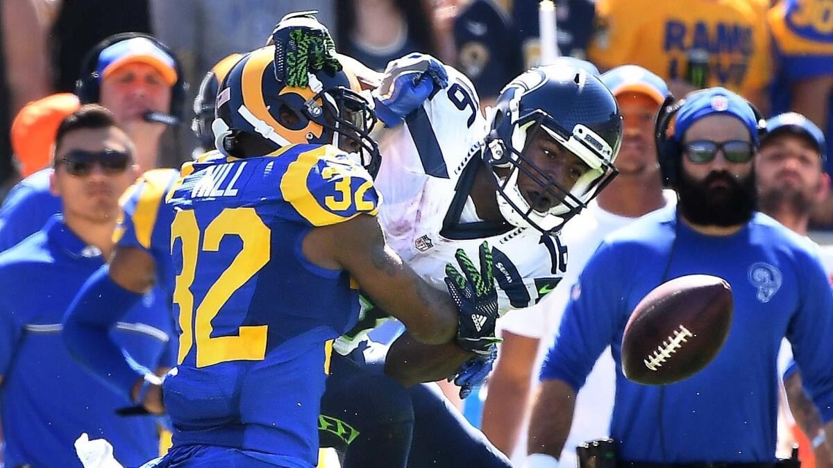 Rams cornerback Troy Hill is called for pass interference as he defends against Seahawks receiver Tyler Lockett in the second quarter Sunday.