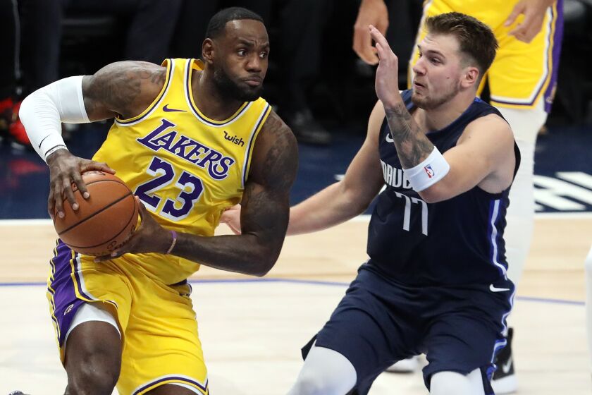 DALLAS, TEXAS - NOVEMBER 01: LeBron James #23 of the Los Angeles Lakers dribbles the ball against Luka Doncic #77 of the Dallas Mavericks in the first quarter at American Airlines Center on November 01, 2019 in Dallas, Texas. NOTE TO USER: User expressly acknowledges and agrees that, by downloading and or using this photograph, User is consenting to the terms and conditions of the Getty Images License Agreement. (Photo by Ronald Martinez/Getty Images) ** OUTS - ELSENT, FPG, CM - OUTS * NM, PH, VA if sourced by CT, LA or MoD **