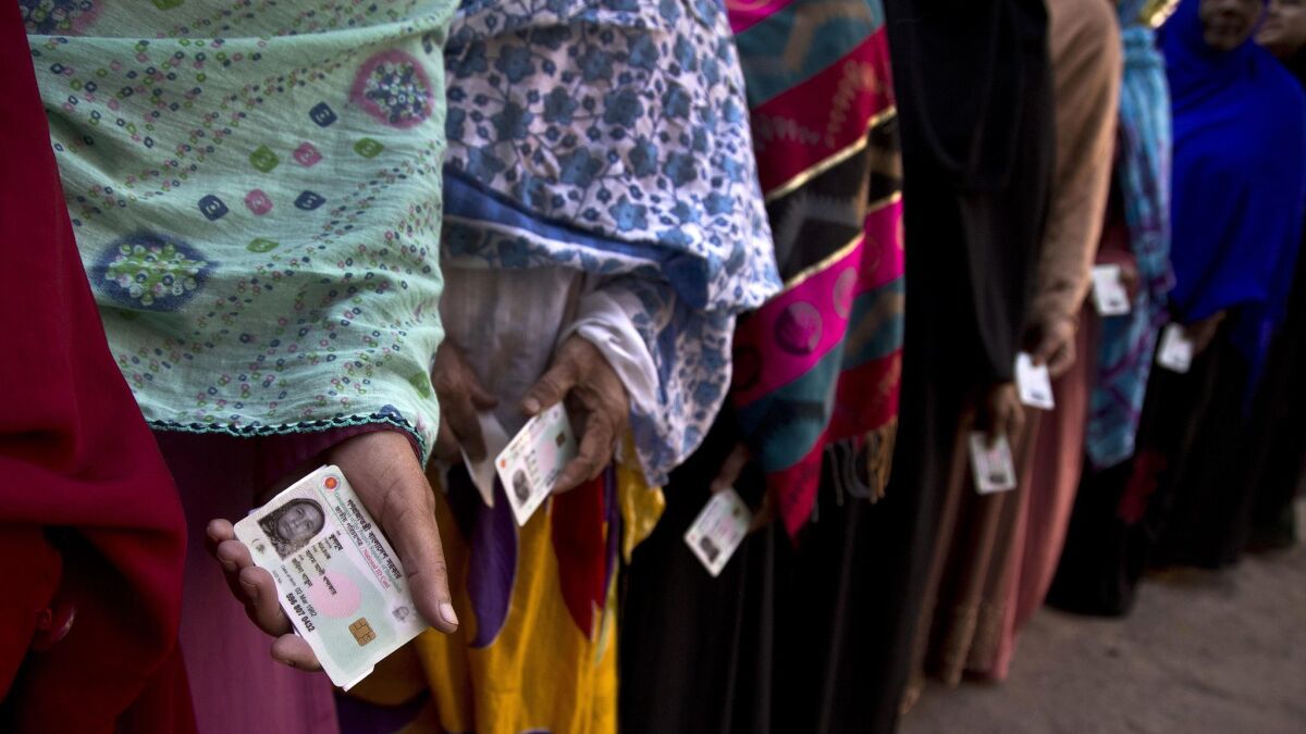 Bangladeshi women line up outside a polling station to vote in Dhaka, the capital, on Sunday in contentious parliamentary elections, seen as a referendum on what critics call Prime Minister Sheik Hasina Wajed's increasingly authoritarian rule.