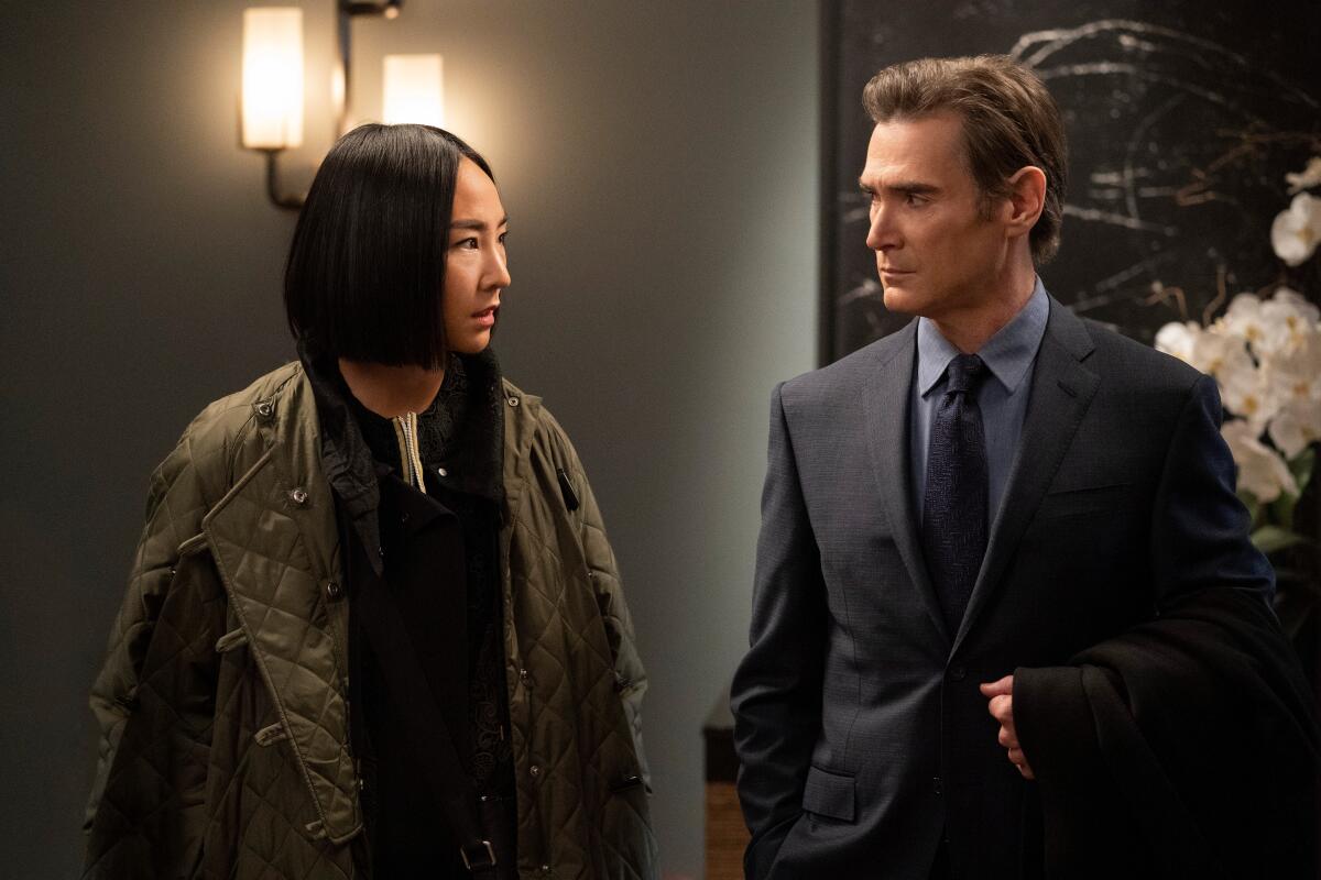 Greta Lee, in an olive green bomber jacket, and Billy Crudup, in a suit and tie, in "The morning program." 