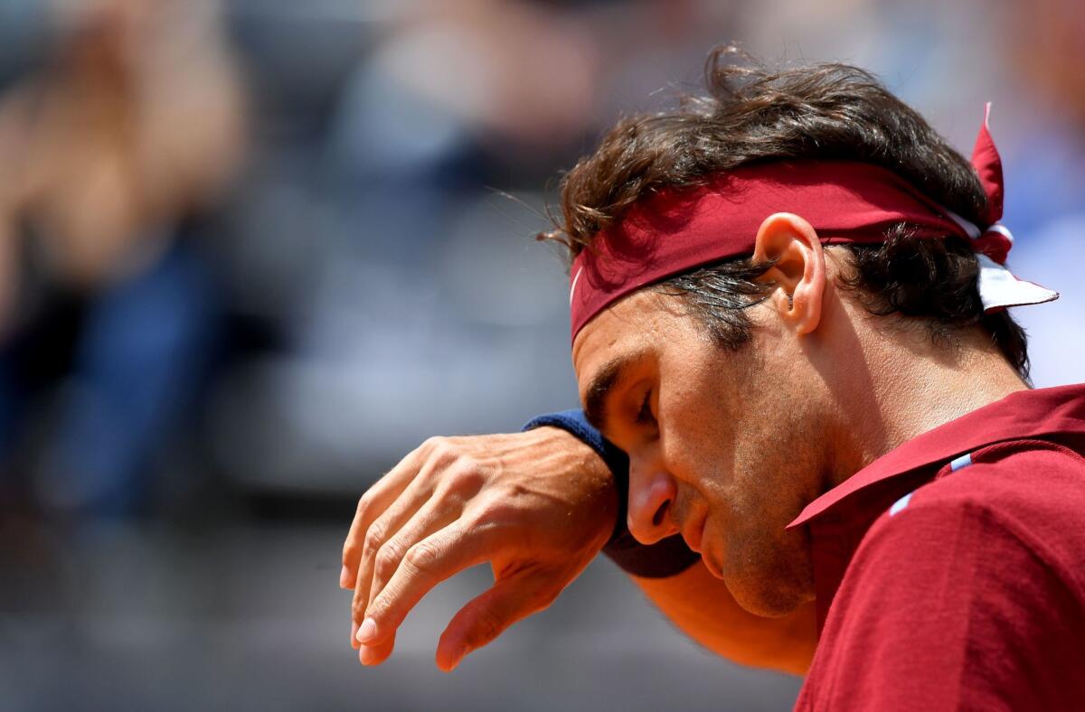 Roger Federer wipes his face during his match against Dominic Thiem during the Italian Open on May 12.