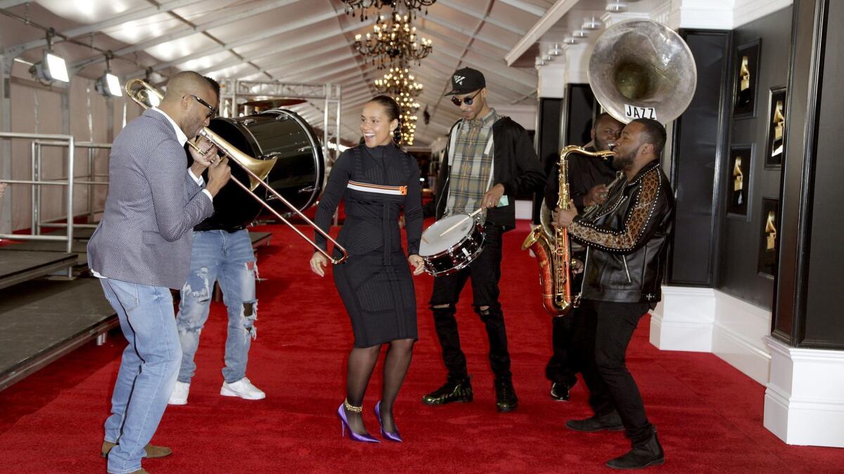 Alicia Keys, 15-time Grammy winner, dances to the music of Trombone Shorty during the red carper roll out for this year's Grammys, which she's hosting for the first time.
