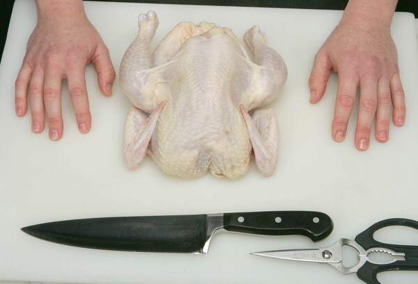 Buying a chicken and cutting it up at home can be cheaper than buying it already cut up at the supermarket. Just follow these steps. You'll need a sturdy pair of kitchen shears and a sharp knife. Rinse off the chicken and pat it dry and place it on a cutting board.