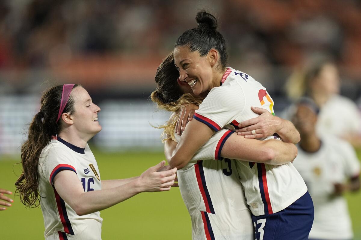 Samantha Mewis, center, celebrates with Christen Press and Rose Lavelle after scoring a goal.