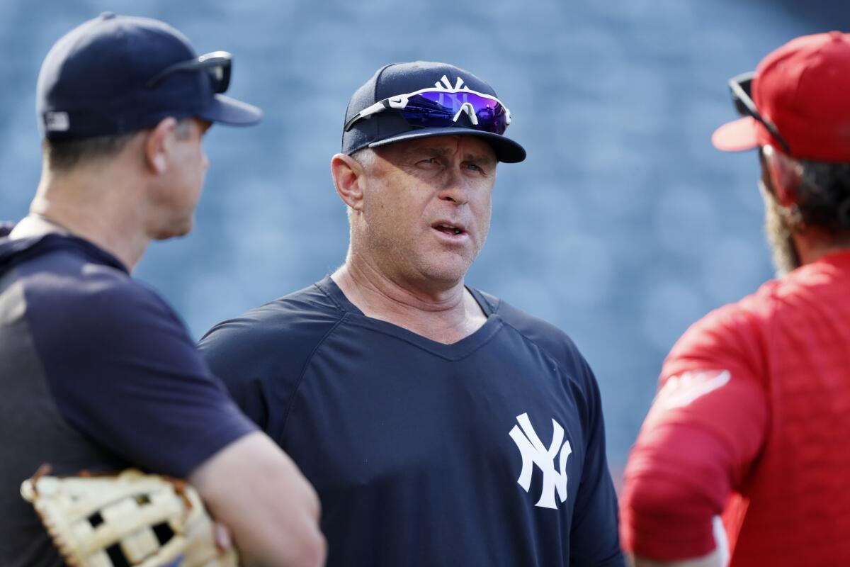 New York Yankees third base coach Phil Nevin talks to players before a game against the Angels on Aug. 31.