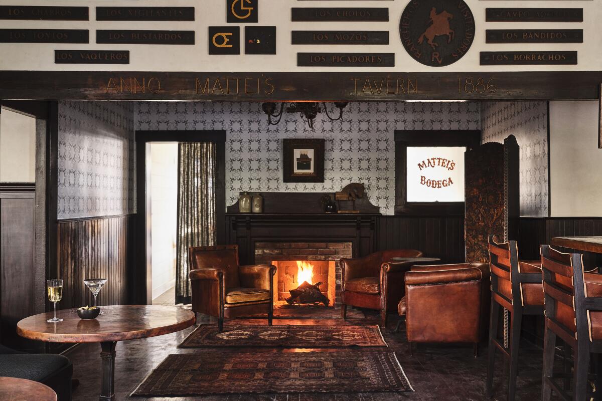 The interior of Mattei's Tavern features a blazing fireplace and dark wood trim.