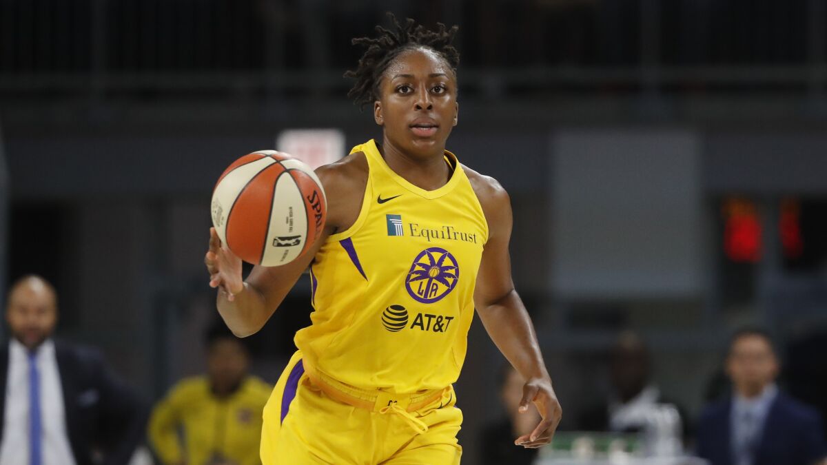 The Sparks' Nneka Ogwumike advances the ball during the second half of a WNBA basketball game.