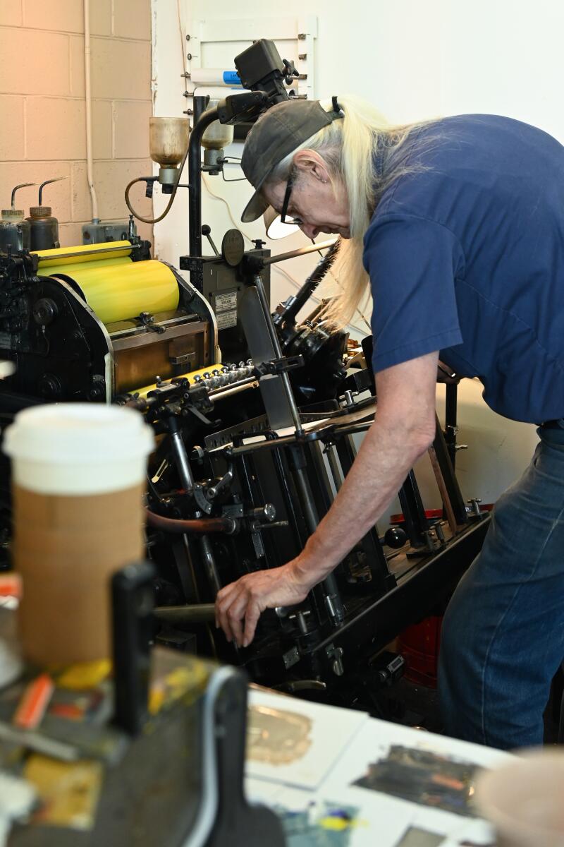 Master Printer Bill Berkuta prints an order for a customer.