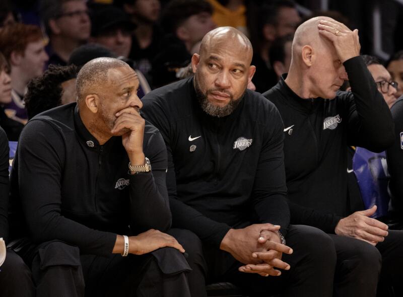 Lakers coach Darvin Ham, center, sits on the bench during the final moments of Sunday's loss.