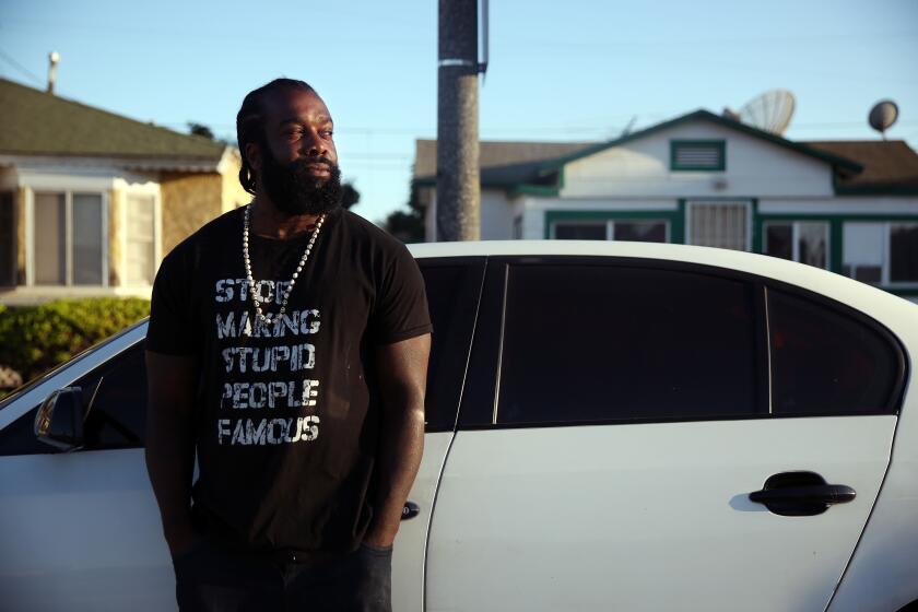 LOS ANGELES, CA-AUGUST 20, 2019: Bryant Mangum, who has been pulled over and searched many times by the Los Angeles Police Department, stands for a portrait by his car which he was driving when he was pulled over on August 20, 2019 in Los Angeles, California. Los Angeles police officers search African Americas and Latinos more often than whites during traffic stops, even though whites are more likely to be found with illegal items, a Times analysis found. (Photo By Dania Maxwell / Los Angeles Times)