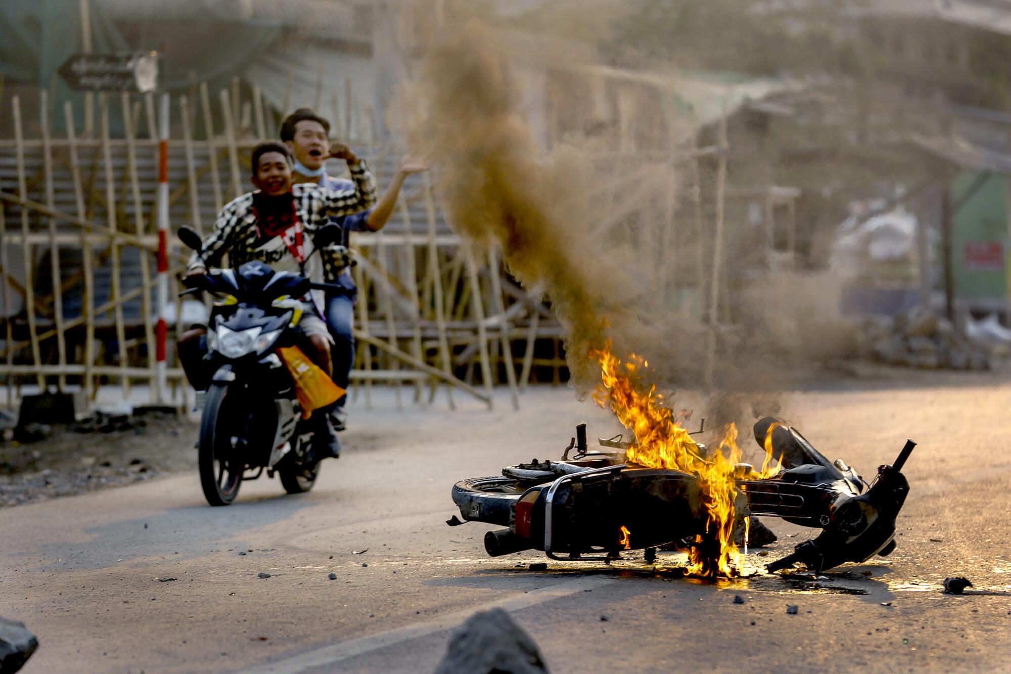 Two men on a motorbike.