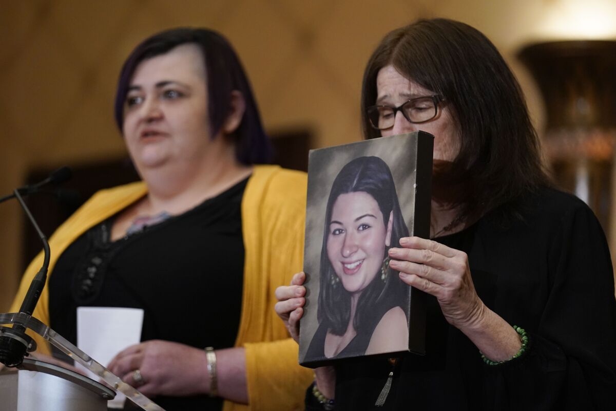 The mother of Rachel D'Avino, who was killed at Sandy Hook Elementary in 2012, holds her daughter's picture.