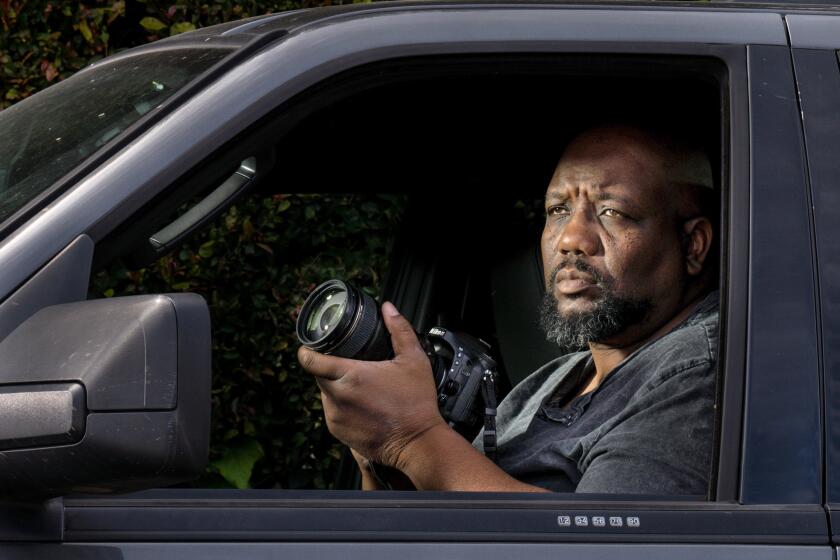 LOS ANGELES, CA - MARCH 28: Photographer Giles Harrison poses for a portrait in his car while driving around the Pacific Palisaides on Saturday, March 28, 2020 in Los Angeles, CA. Paparazzi like Harrison are still out looking for celebrties, even at a time when no one is going out in L.A. due to the coronavirus pandemic. (Kent Nishimura / Los Angeles Times)