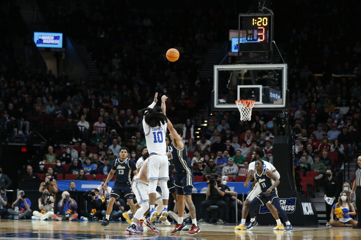 UCLA guard Tyger Campbell shoots a three-pointer against Akron.