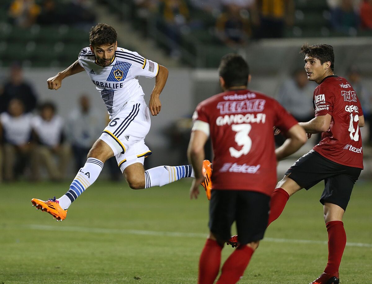 Galaxy midfielder Baggio Husidic, shown attempting a header against Club Tijuana on March 12, has scored once in four starts this season and solidified a diamond midfield that has been reconfigured to get the ball to striker Robbie Keane.
