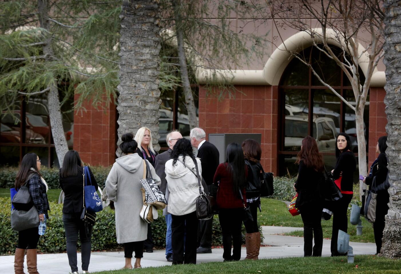 Employees wait to enter the Inland Regional Center complex in San Bernardino as it reopens for the first time since a mass shooting there last month that left 14 people dead.