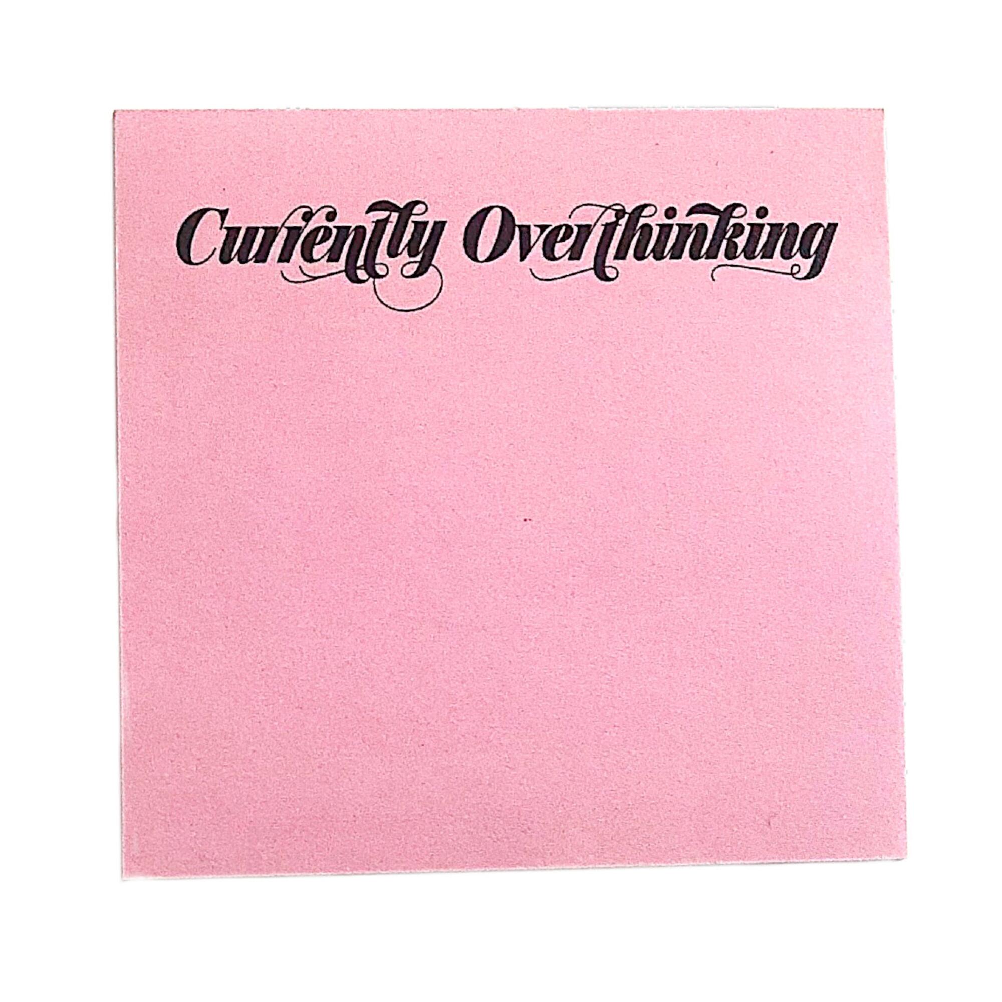 A pink pad of Post-it notes with "Currently overthinking" printed at the top