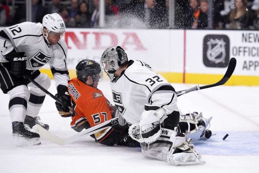 Ducks left wing David Perron, center, scores against Kings goalie Jonathan Quick and right wing Marian Gaborik on Feb. 4. Perron and Gaborik are two of the many injured as the playoffs open.