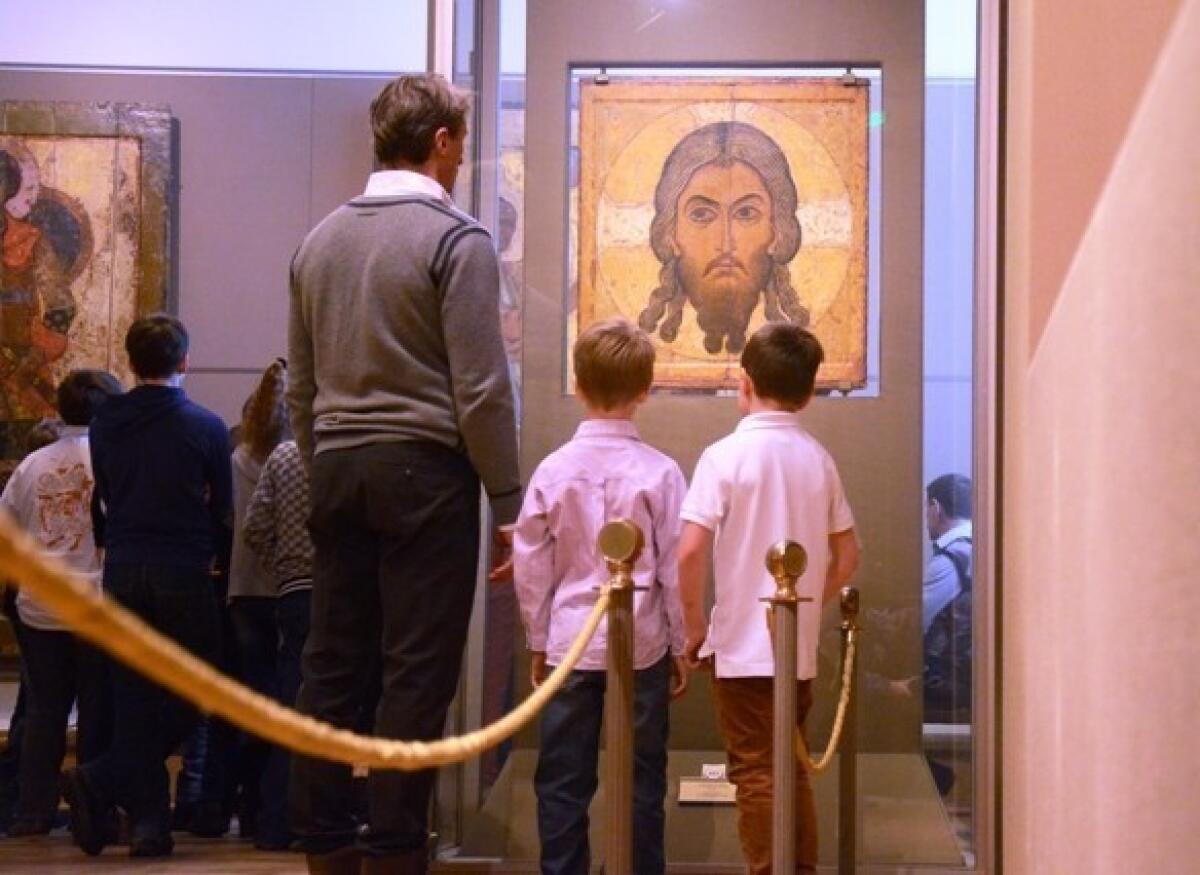 A family views religious art at the Tretyakov Gallery in Moscow.