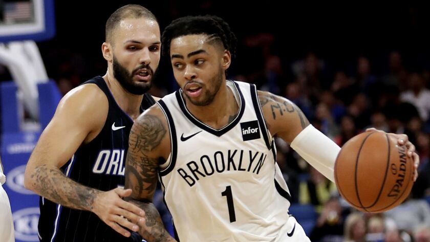 Nets guard D'Angelo Russell drives past Magic guard Evan Fournier en route to matching his career high with 40 points Friday night in Orlando.