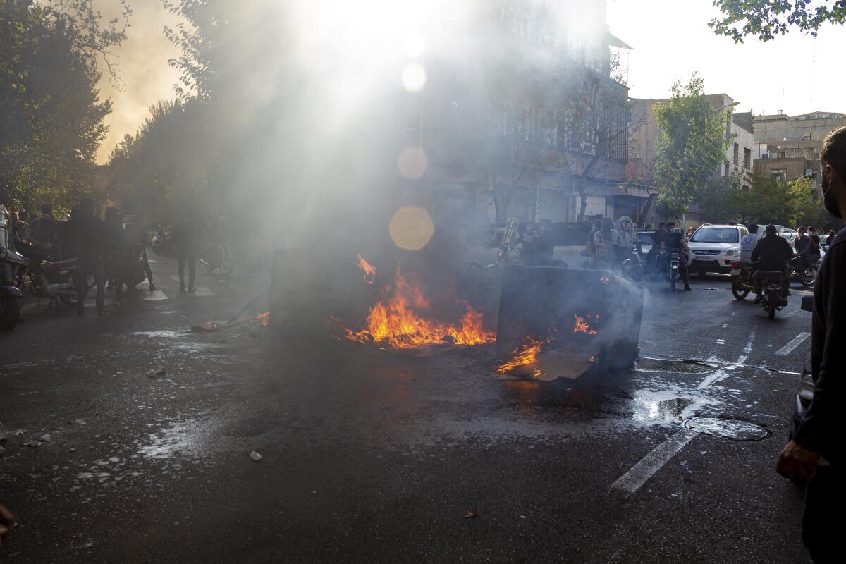 Debris is on fire in the streets of Tehran, Iran, during a protest.
