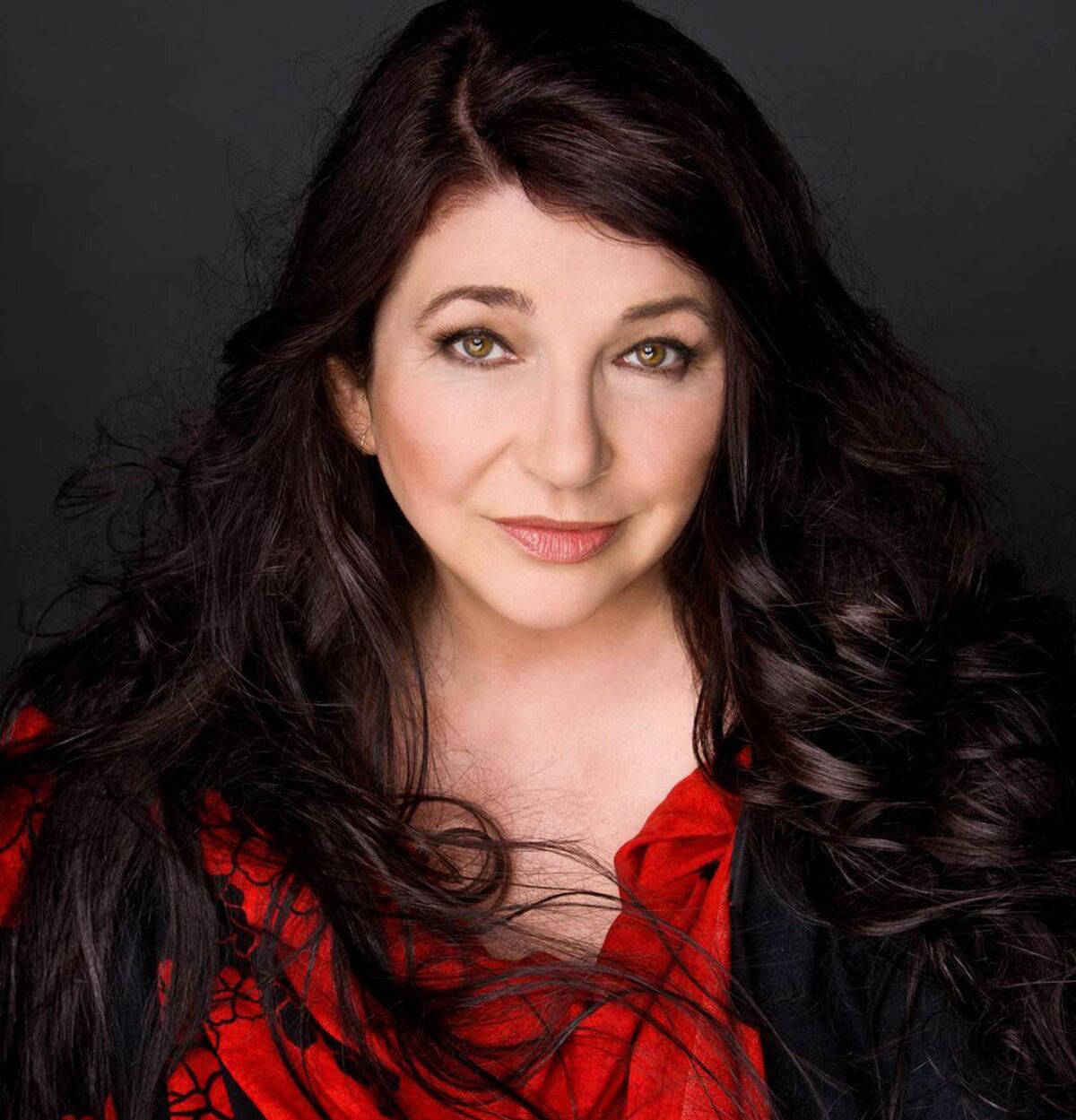 A woman with long dark hair.